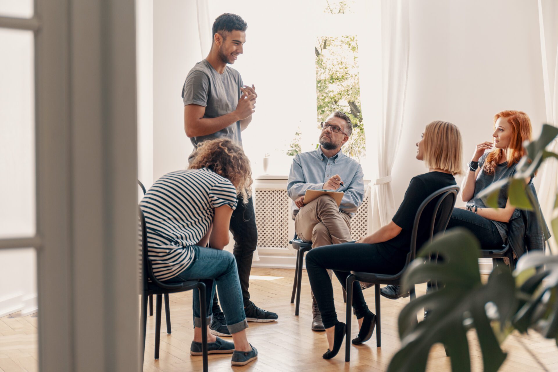 three people talking around a table